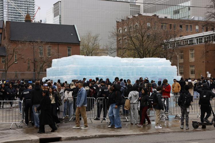 Crowd gathered around the ICEMAN ice wall installation in Toronto